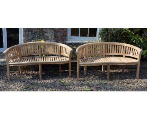 A pair of teak garden benches, of recent manufacture  A pair of teak garden benches,   of recent manufacture, each with arche