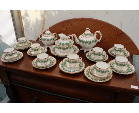 A 19TH CENTURY PORCELAIN TEA SERVICE with turquoise and gold decoration on a white ground, including teapot, sucrier, milk ju