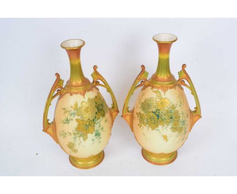 Pair of early 20th century Royal Worcester vases, the ovoid bodies with blush ground and green and gilt decoration, flanked b