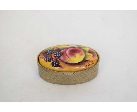 A pill box probably Royal Worcester the cover with painted fruit decoration signed by T Nutt the white metal base with scroll