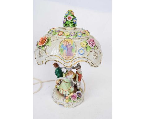 Continental porcelain lamp and shade with applied floral decoration, the base with series of figures, the pierced cover with 