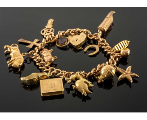 18CT GOLD CURB LINK CHARM BRACELET, 9ct gold heart padlock, with mostly 9ct gold charms and yellow metal charms including whi