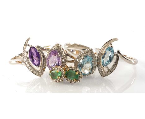 TWO PAIRS AMETHYST OR TOPAZ DRESS RINGS, including pear cut and marquise cut stones within diamond borders, set in unmarked w