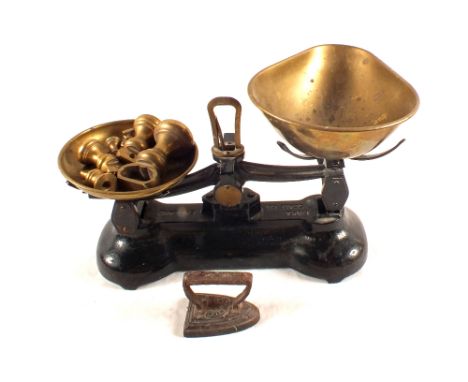A Brass pan kitchen scales and weights plus a miniature flat iron