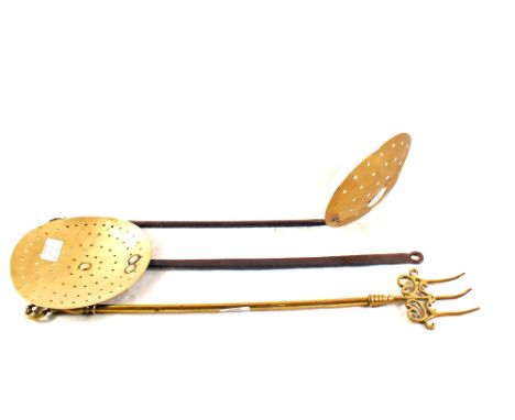 Two antique Brass and Iron cream skimmers and a decorative 19th Century Brass toasting fork