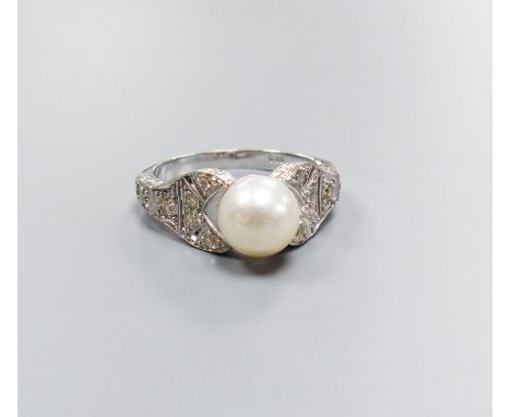   A modern 750 white metal and single stone cultured pearl dress ring, with diamond chip set pierced shoulders, size R/S, gro