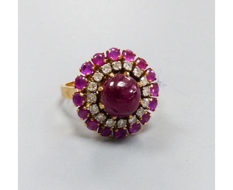   An Indian yellow metal, cabochon ruby and diamond cluster ring, size N, gross weight 8.3 grams, (central stone cracked).