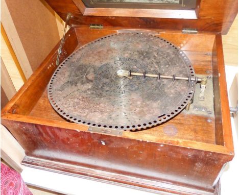   A Walnut and marquetry cased polyphon, 54cm and various 40cm discs