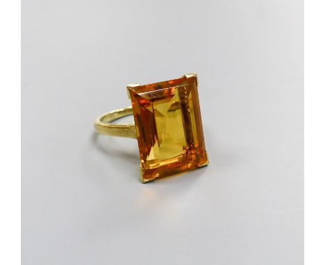   A modern yellow metal and emerald cut citrine set dress ring, size K, gross weight 6.6 grams.