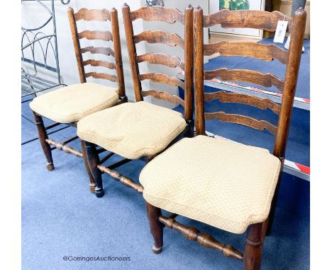   A harlequin set of eight ash rush seat ladder back dining chairs with squab seats