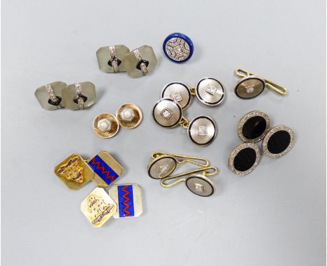   A pair of yellow and white metal, diamond and black enamel cufflinks and three similar dress studs, 11mm, one stamped 14k, 