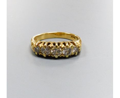   A five-stone diamond ring, 18ct yellow gold setting, claw-set with carved shoulders, size K, gross 5.5 grams.