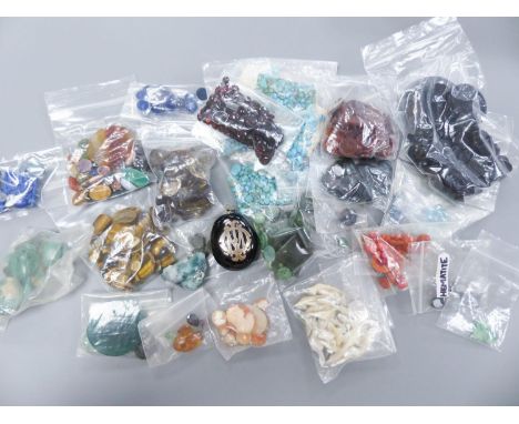   A quantity of assorted unmounted gemstones including, opal, opal doublet, malachite, chalcedony, tiger's eye quartz, hemati