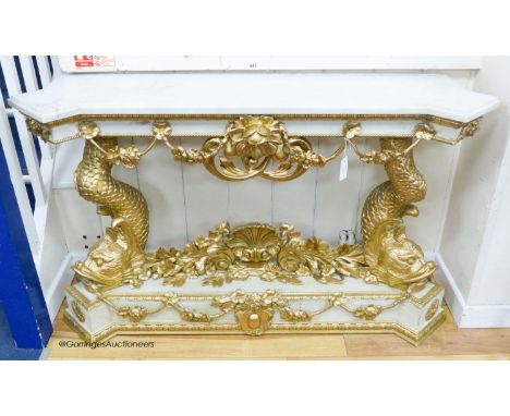   A Louis XVI style painted composition and giltwood console table on dolphin supports, width 146cm, depth 43cm, height 85cmr