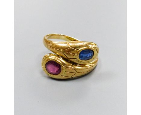   An 18ct yellow gold double 'cobra' ring, sapphire and ruby set, size Q/R, gross 7.6 grams.