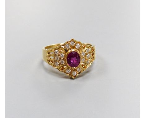   A modern 14ct gold, single stone ruby and diamond chip cluster set dress ring, size O, gross 4.1 grams.