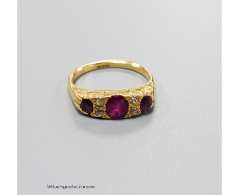   An early 20th century 18ct, three stone ruby and four stone diamond chip set half hoop ring, size L, gross 4.1 grams.