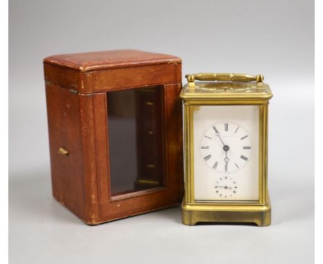   An early 20th century French brass carriage clock with alarm, 16cm high handle up, cased