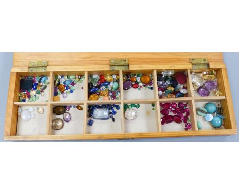   A quantity of unmounted gemstones, housed in a wooden box, including opal, opal doublet, bloodstone, turquoise, amethyst, r