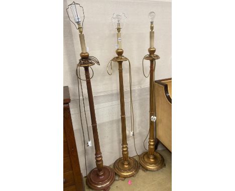   A set of three gilt carved wood lamp standards, height excluding fittings 135cm