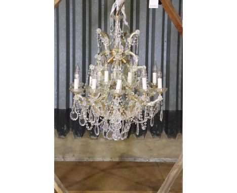 A Maria Theresa-style chandelier,20th century and later, with twenty lights raised on scrolling arms and festooned in cut-gla