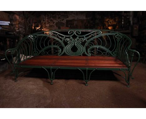 An Art Nouveau painted wrought-iron garden bench, early 20th century and later, with pierced scrolling decoration and a slatt