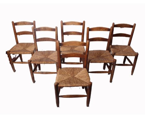 A set of six 19th century country ladder back beech and elm dining chairs with woven seats