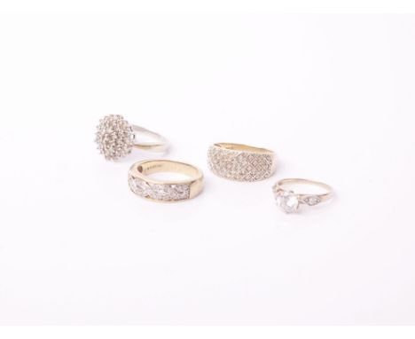 Three 9ct gold and diamond dress rings and a cubic zirconia ring, comprising; a small diamond three row target cluster ring, 