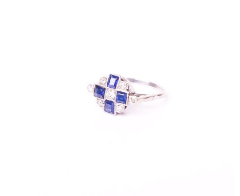 An Art Deco sapphire and diamond cluster later mounted as a ring probably in the 1950’s, the four rectangular step-cut sapphi