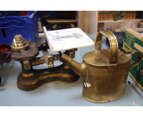 A 19th Century brass fender, a set of Victorian scales and a brass kettle (3)