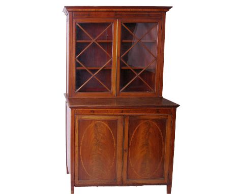 An Edwardian mahogany and inlaid cabinet bookcase, circa 1905, the glazed doors enclosing adjustable shelves, the base with a