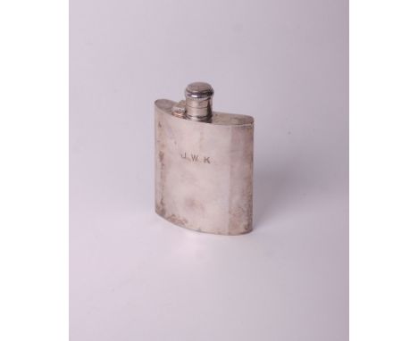 A silver concave hip flask with a hinged screw cover &amp; engraved on the side with initials ‘J.W.K’ and beneath ‘A Davis 20