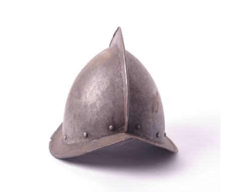 Armour: a coned Morion Pikemans helmet, no lining, domed rivets, peaked rim, 17th century h.25cm 