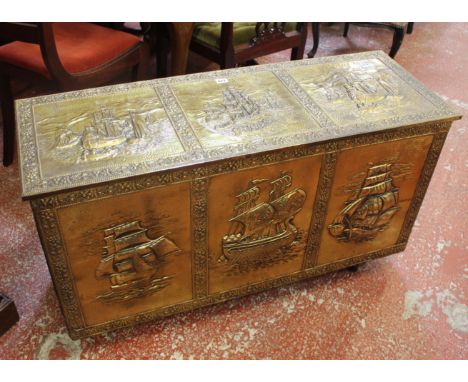 A 20th century coffer with pressed brass panel facings (width 107cm) with contents: a brass horn, bed warming pan and a ice b