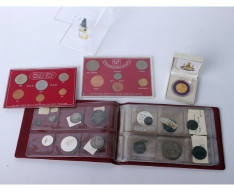 A pocket coin album containing twelve early GB coins, two cased 1967 Decimal sets, a boxed Thai Airways commemorative medalli
