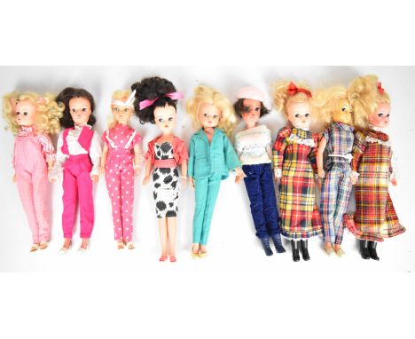 Nine vintage Sindy dolls by Pedigree dressed in 1980's outfits to include Well Suited, Fashion Fun, Candy Stripe, Cocktail Pa