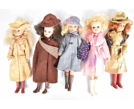 Five vintage Sindy dolls by Pedigree dressed in 1980's Autumnal outfits including hats, scarves, raincoats and boots.