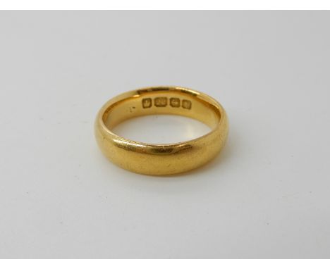A 22ct gold wedding ring size M, weight 7.5gms Condition Report:Width of the ring 4.9mm. Medium general wear, no splits no fr