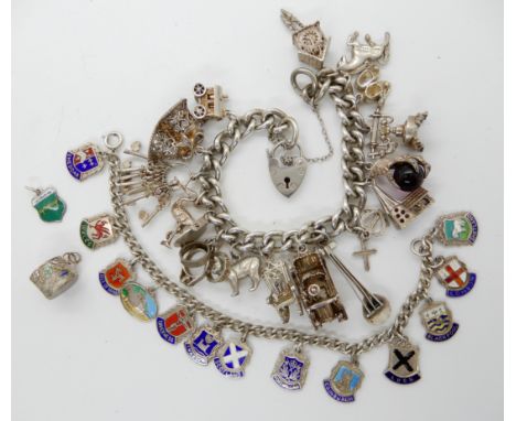 An extensive silver charm bracelet to include a Shetland silver horse charm and a Manx cat, and a further silver and enamel p
