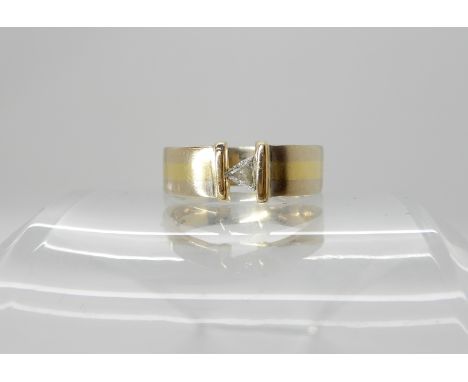 An 18ct yellow and white gold ring set with a trilliant cut diamond of estimated approx 0.20cts, finger size P, weight 6.7gms