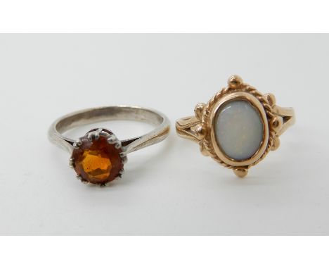 A 9ct gold opal set ring size L, weight 2.6gms together with a white metal orange gem set ring Condition Report: Available up