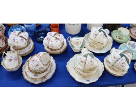 A Foley china teaset, decorated with daisy like flowers on a cream ground, comprising eleven cups, twelve saucers,  twelve pl