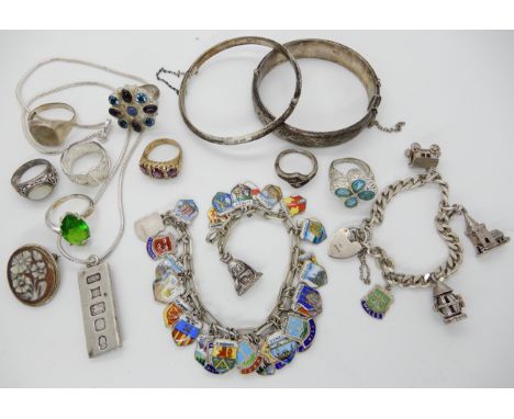 A silver and enamel place name charm bracelet a further charm bracelet a silver ingot pendant and other items Condition Repor