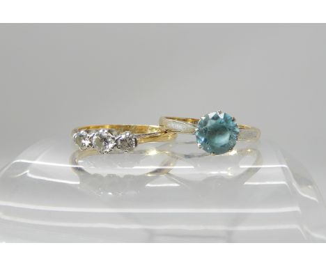 A 9ct gold blue zircon ring size N1/2, weight 2gms, together with an 18ct gold three stone diamond ring of estimated approx 0