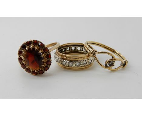 A 9ct garnet cluster ring size P1/2, a 9ct full clear gem set eternity ring size K, and a further 9ct ring size N1/2, combine