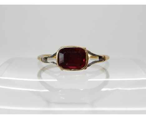 A yellow metal early Victorian style garnet ring, size approx R, weight 2gms Condition Report: Available upon request