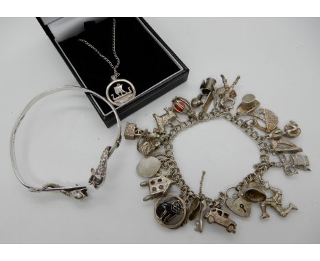 An extensive silver charm bracelet, a silver dolphin bangle and a Longship pendant Condition Report: Not available for this l