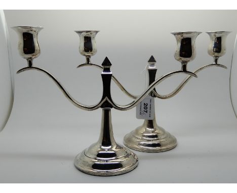 A pair of Hong Kong sterling silver two-light candelabra (weighted) marked Walker Sterling Hong Kong, 19.5cm high (2) Conditi