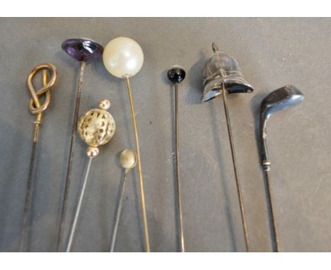 A Birmingham Silver Hat Pin in the form of a police helmet, together with another in the form of a golf club and various othe