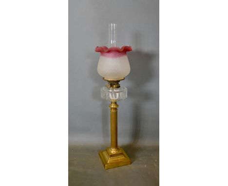 An Edwardian Brass Oil Lamp with opaque glass shade and chimney with reeded column and square platform base, 74cm tall 